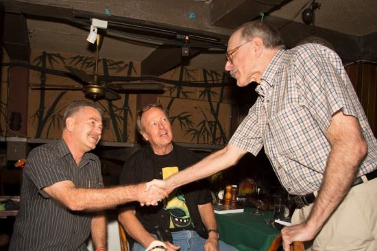 Kevin Cummings looks on as Alan Parkhouse of the Bangkok Post shakes hands with Bangkok author Dean Barrett
